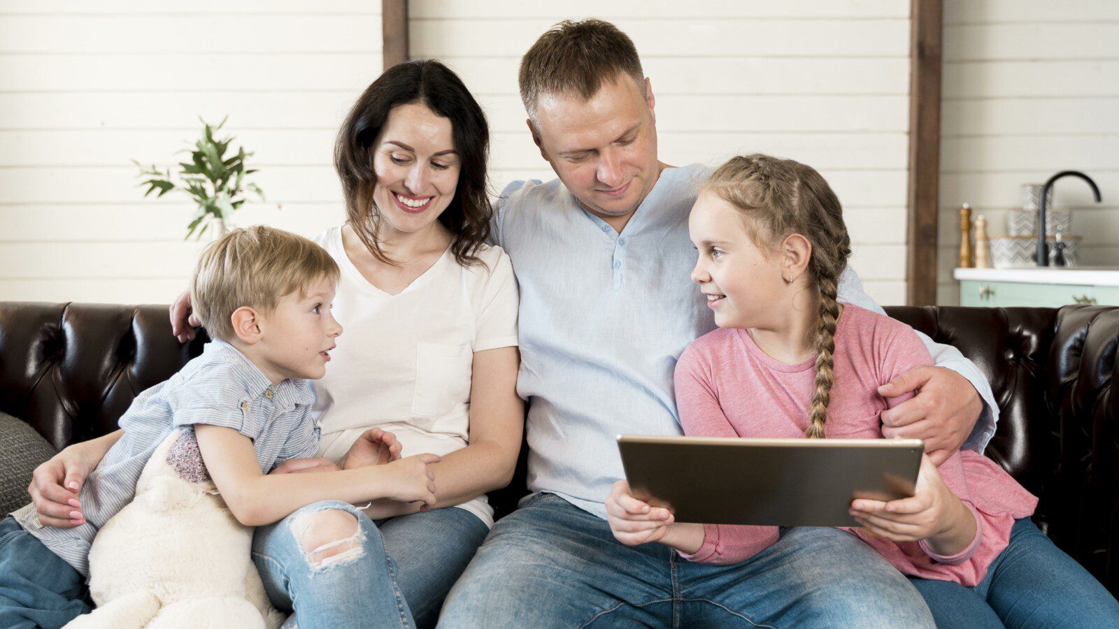 front-view-happy-family-with-device